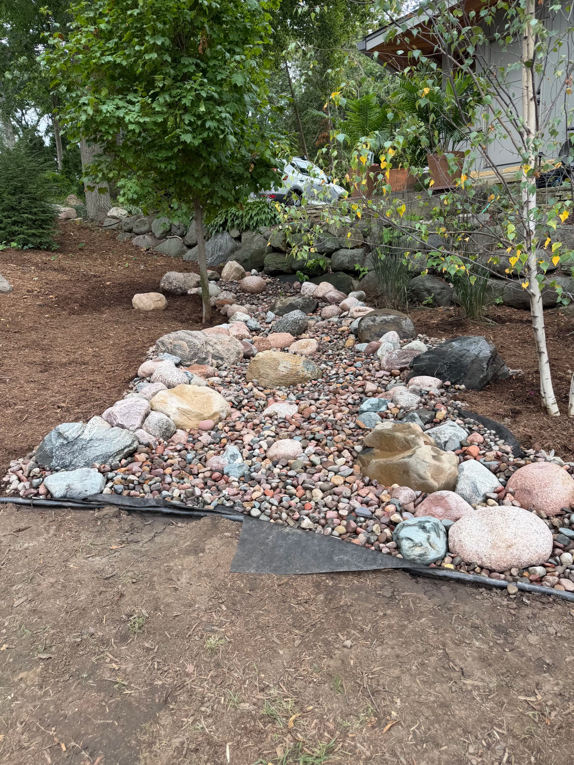 Gallery photos for Dry Creek Bed, Regrading, and Fresh Lawn Fix a Runoff Problem: Image #1
